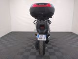 a motorcycle that is parked in a room with a checkered floor
