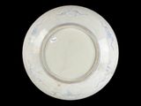 a white plate with blue designs on it on a black background