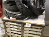 a pile of tires and a helmet on top of a shelf