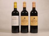 trois bouteilles de vin sont alignées sur une table
