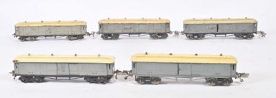 four gray and yellow train cars sitting on top of a white surface