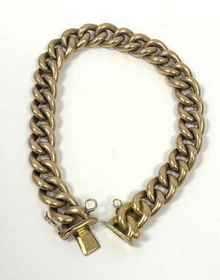 a gold chain bracelet with a lock on a white background