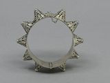an image of a silver ring on a gray surface