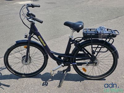 a bike that is parked on the street with a basket on the back