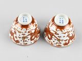 two brown and white vases sitting on top of a table