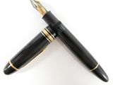 the pen is black with gold trimmings and has a gold tip