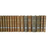 a row of old books sitting on a shelf