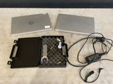 two laptops that are sitting next to each other on a table