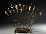 a metal sculpture of a bunch of birds on top of a wooden stand