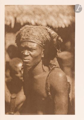 a black and white photo of a man wearing a headdress