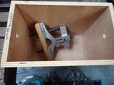 a wooden box with a clamp in it on a pallet