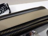 a black and white purse with a black and white strap