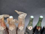 several bottles of wine are wrapped in plastic and sitting next to each other