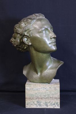 a bronze bust of a woman with curly hair on a marble base