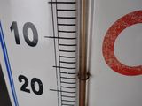 a thermometer with a red circle on the side of it