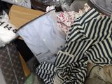 a pile of clothes and other items on the floor