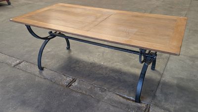 a wooden table with a metal base and a wooden top