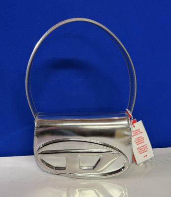 a close up of a silver purse with a tag on it