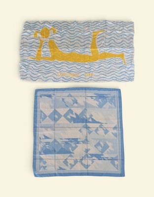 two towels with a picture of a woman in a boat on them