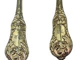 pair of antique silverplated spoons with ornate designs