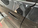 a close up of a car door handle with a sticker on it