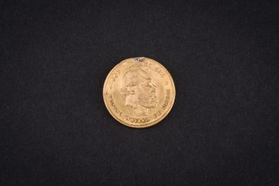 a close up of a gold coin on a black background