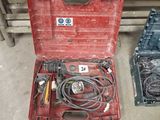 a red tool box with tools in it on the floor