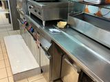 a kitchen with a lot of stainless steel appliances in it