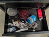 a drawer full of assorted items on the floor