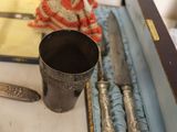 a box with silverware on a table next to other items