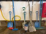 a lot of shovels, a bucket, and a bucket on the floor