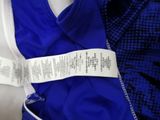 a close up of a blue and white shirt with a label on it