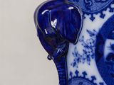 a blue and white vase with an elephant on it