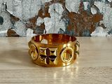 un gros plan d'une bague en or posée sur une table en bois
