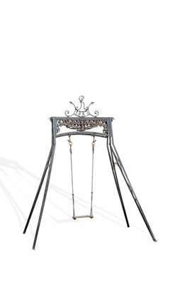 a metal swing with a bird on it on a white background