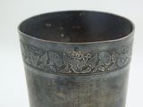 a metal cup with a design on it