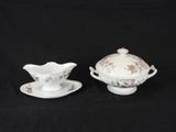 two pieces of porcelain ware are sitting on a black surface