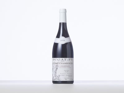 a bottle of red wine sitting on a table