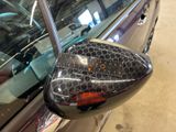 a close up of a car ' s side view mirror with the word stop written on it