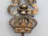 a gold clock with a crown on top of it