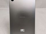 a close up of the back of a silver samsung tablet