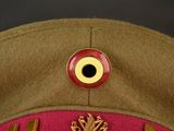 an image of a military hat with a red eye on it