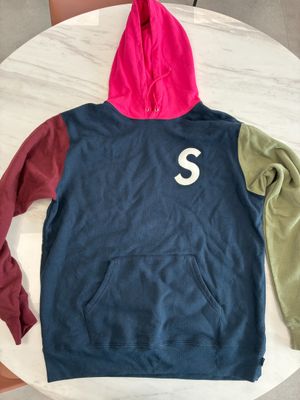 hoodie with the letter s on it sitting on top of a table