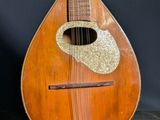 an old wooden guitar with a hole in the middle of it