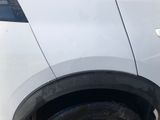 a picture of a white car parked in a lot