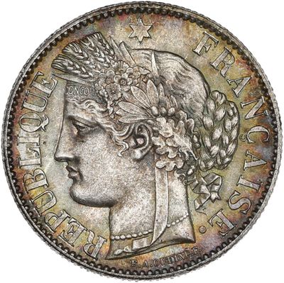 a silver coin with a woman ' s head on it
