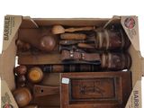 a cardboard box with a bunch of wooden tools inside of it
