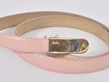 pink leather belt with gold buckle on a white background