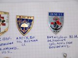 several badges on a piece of paper with writing on them