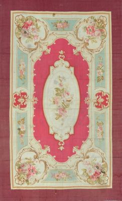 a red and green rug with a picture of flowers on it
